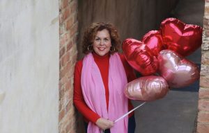 Debbie holding heart balloons - grace and aging