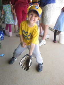 Young Child Learning to play baseball.